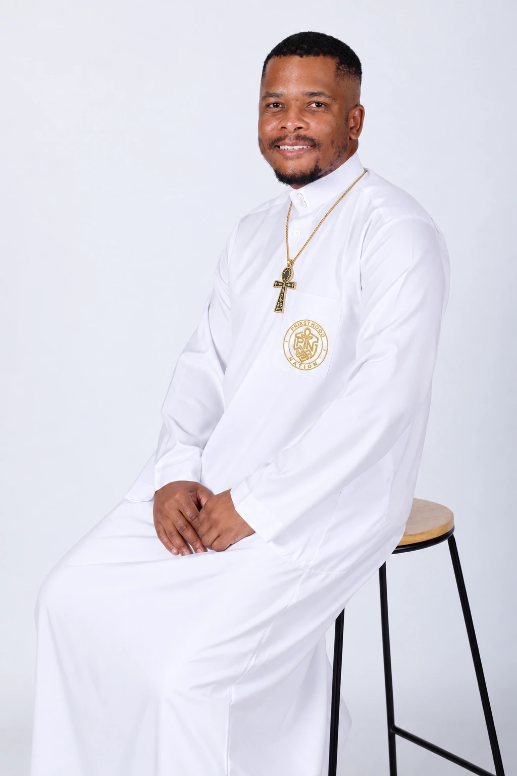 Phiwa Nkambule wearing the golden ankh and the Priesthood Nation embroidered crest